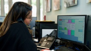 Member of staff on phone scheduling an appointment